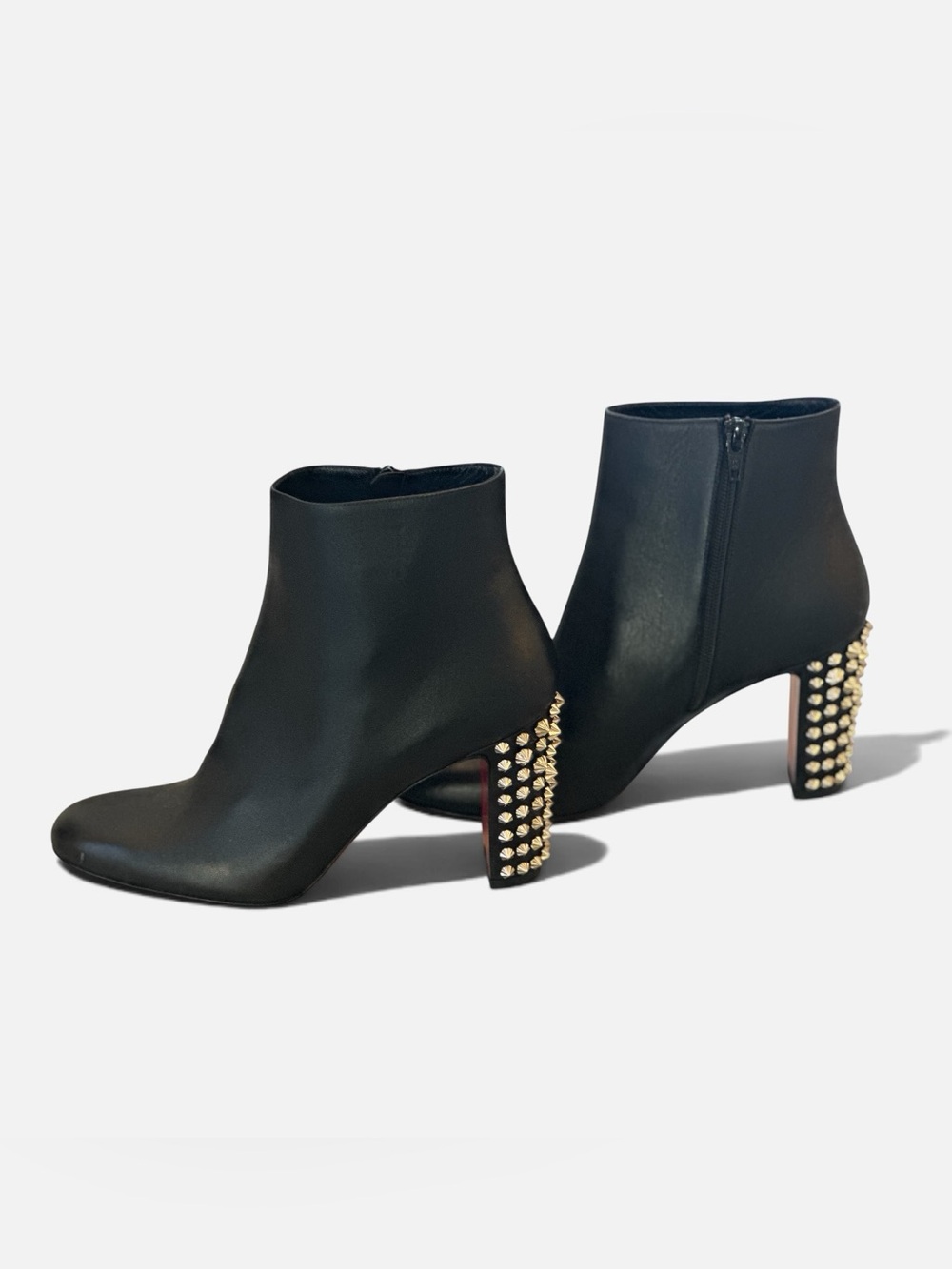 Christian Louboutin black leather ankle boot embellished with gold-tone studs